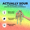 A hand holding vibrant Rainbow-Six Pack sour candy strips from SourStrips is centered in the image. Text above reads: "ACTUALLY SOUR" with a subheading "Get ready for an extremely sour candy experience." Icons and text below highlight features: "resealable bag," "vegetarian friendly," and "twelve strips per pack." The background is a gradient of green, yellow, and red with watermarked