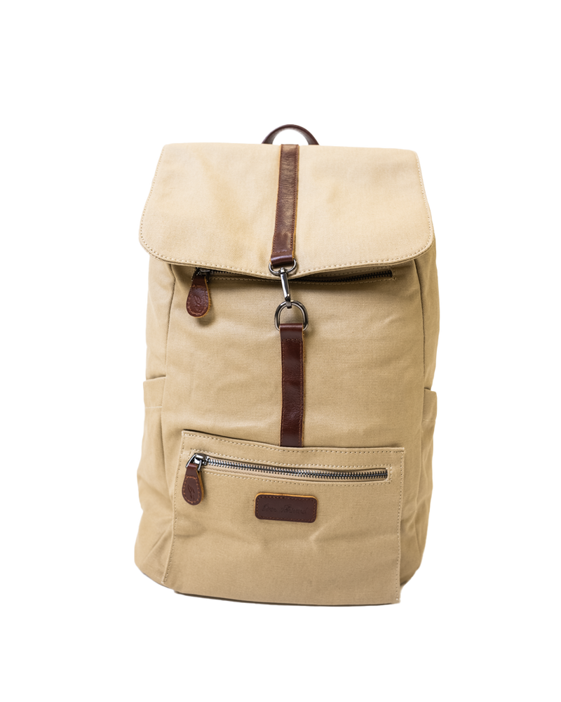 Introducing the Sick Backpack from SourStrips: a beige fabric backpack accented with brown leather, ideal for anyone in search of a stylish and practical accessory. It boasts a front zipper pocket with a leather pull tab, a top flap secured by a leather strap and metal clasp, and a convenient small side pocket. The design is clean and functional.