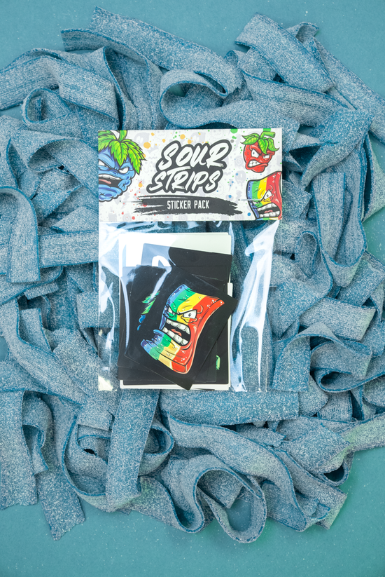 A SourStrips Sticker Pack is placed on a bed of blue sour candy strips. The packaging showcases vibrant, animated designs of sour candy characters and includes several kiss cut sticker sheets with different designs visible through the transparent material.