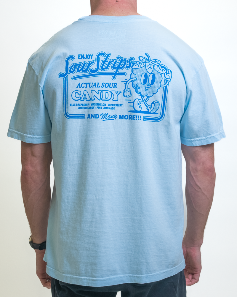 Someone is wearing a Retro Blue Raspberry Tee from SourStrips, an oversized box fit light blue T-shirt with a back graphic of a cartoon character and the text "Enjoy Sour Strips, Actual Sour Candy," featuring various flavors.