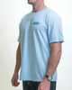 A person wears a Retro Blue Raspberry Tee by SourStrips, featuring an oversized box fit and small chest logo. With arms at their sides and a watch on the left wrist, they stand against a plain white background.