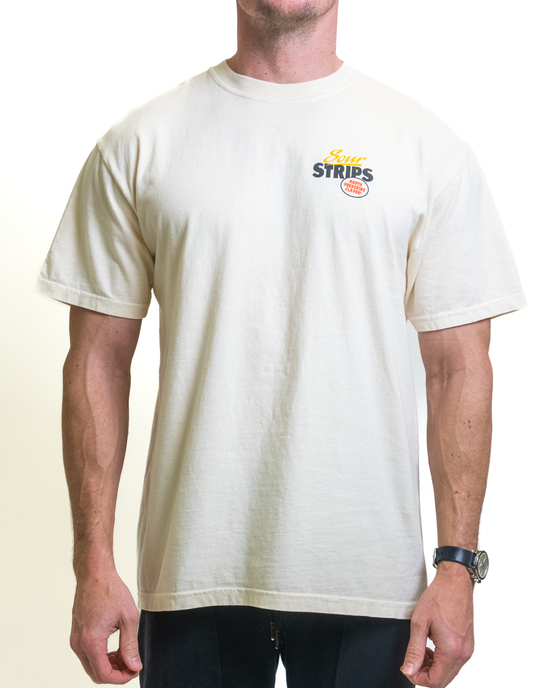 A person wears an oversized unisex Retro Watermelon Tee by SourStrips, featuring a small "STRIPS" logo and circular emblem on white. The shirt's elegant fit complements their left-wrist watch, emphasizing the stylish minimalism of this graphic T-shirt against a clean white backdrop.