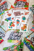 The SourStrips Holiday Gift Box-Fourteen Pack features colorful candy packages and festive cartoon stickers with Christmas designs—perfect for gifting or collecting these limited edition holiday-themed treats.