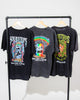 Three Blue Venom Tees by SourStrips hang on a rack. Each unisex cotton shirt features bold, colorful graphics and the text "Sour Strips" and "Sour Candy to Die For" on the back, making them standout graphic T-shirts for any collection.
