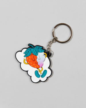 The SourStrips Dreamberry Keychain features a cute cartoon strawberry and blueberry with arms, legs, and faces sitting together on a white cloud-shaped background, appearing to kiss for a sweet touch.