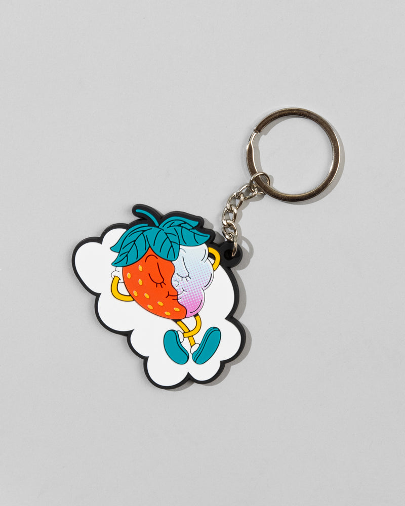 The SourStrips Dreamberry Keychain features a cute cartoon strawberry and blueberry with arms, legs, and faces sitting together on a white cloud-shaped background, appearing to kiss for a sweet touch.