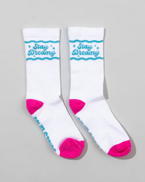 SourStrips Dreamberry Crew Socks are unisex white cotton socks with bright pink toes and heels, blue "Stay Dreamy" text and stars at the top, plus additional blue writing partially visible on the soles.