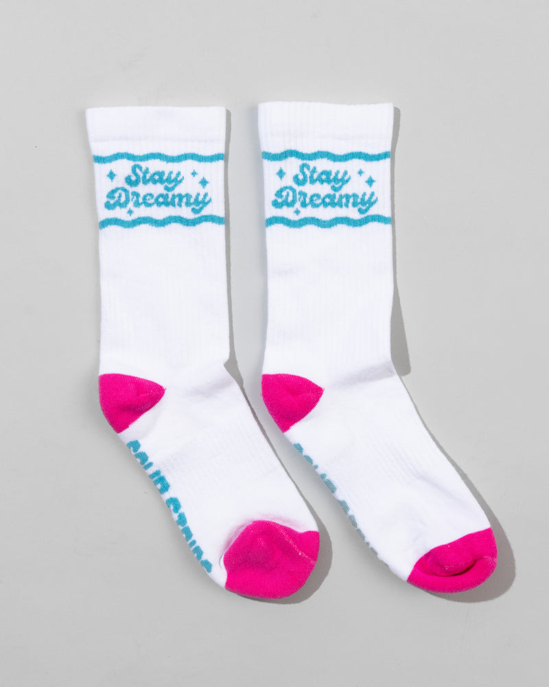 SourStrips Dreamberry Crew Socks are unisex white cotton socks with bright pink toes and heels, blue "Stay Dreamy" text and stars at the top, plus additional blue writing partially visible on the soles.