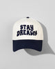 The SourStrips Dreamberry Hat-White features bold "STAY DREAMY" lettering on the front and an embroidered logo, displayed against a light gray background with the cap’s shadow visible.