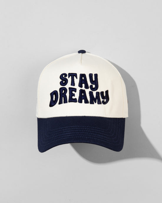 The SourStrips Dreamberry Hat-White features bold "STAY DREAMY" lettering on the front and an embroidered logo, displayed against a light gray background with the cap’s shadow visible.