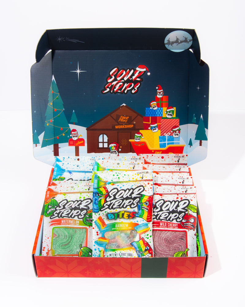 Holiday themed sour strips box open and sitting on a white background. Inside is a colorful decorated box with characters and then the assorted sour strips candy is laying neatly inside the box